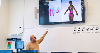 image of a professor pointing at a monitor