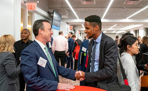 Student shaking hands with employer at NYC Career Trek
